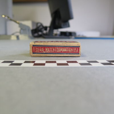 Side of matchbox: Origsize: 0.75" (h) x 1.5" (w); Origformat: Artifact