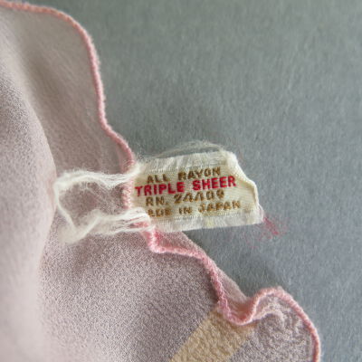 Tag on scarf: Origsize: 8" (w) x 10" (l); Origformat: Artifact