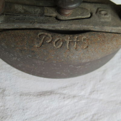 Close up of text on top of iron.: Origsize: 5.5" (h) x 4" (w) x; Origformat: Artifact