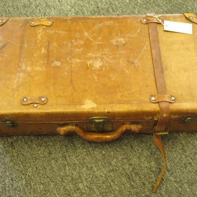 One side of suitcase.: Origsize: 13" (h) x 24" (w) x; Origformat: Artifact