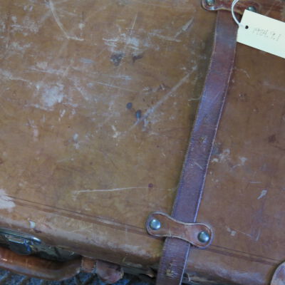 Close up of tag on suitcase.: Origsize: 13" (h) x 24" (w) x; Origformat: Artifact
