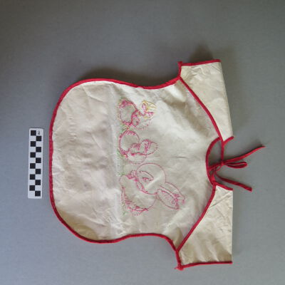Back of bib: Origsize: 14" (w) x 17" (l); Origformat: Artifact