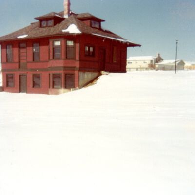 Depot Museum in snow with red and green paint