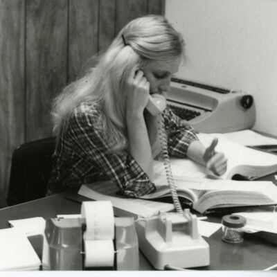 Woman on Phone at Desk