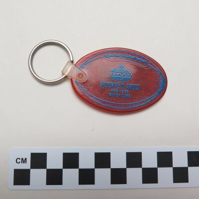 Close up of text on front of key chain.: Origsize: 3.5" (w) x 1.75" (l); Origformat: Artifact