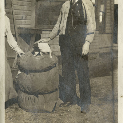 Station Agent Robert Hillen with Puppy by a Mail/Luggage Sack at Superior Depot