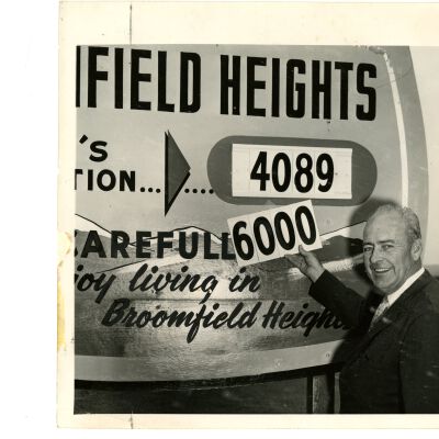 Population Sign with K.C. Ensor in front of it
