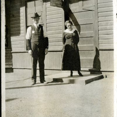 Robert Hillen and wife Jeannie Hillen by telegraph office, circa 1923: Origsize: 2 1/2" x 4 1/4"; Origformat: Print-Photographic; Resolution: 300dpi