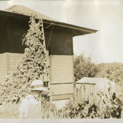 Robert Hillen walking in his yard at the Superior train depot, circa 1928: Origsize: 3 1/2" x 5 3/4"; Origformat: Print-Photographic; Resolution: 300dpi