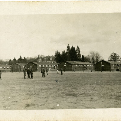 Open Field with Soldiers and Barracks in the Background