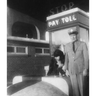 Shep with a Tollbooth Worker and the Tollbooth in the Background - Night