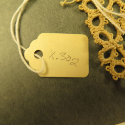 Close up of number on tag.: Origsize: 2" (w) x 2.5" (l); Origformat: Artifact