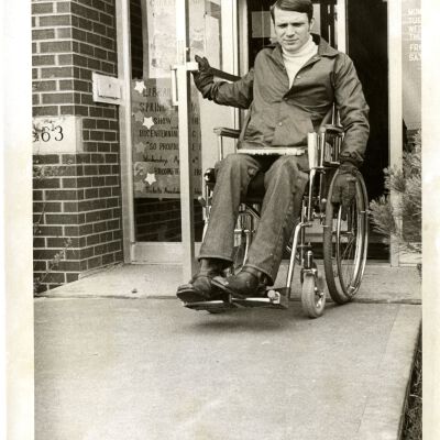 Rob Lewis - Man in wheelchair coming out of Broomfield Library