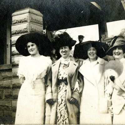Four women in fancy large hats