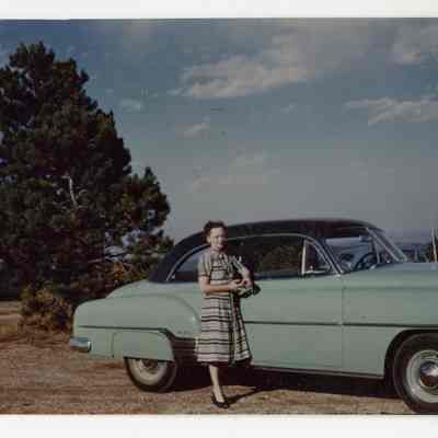 Woman standing next to car