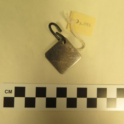 Back of tag.: Origsize: 1.5" (w) x 1.5" (l); Origformat: Artifact