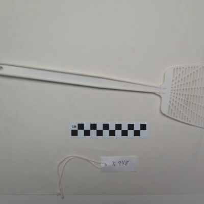 Back of fly swatter.: Origsize: 4" (w) x 15.25" (l); Origformat: Artifact