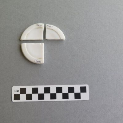 One side of lid.: Origsize: .5" (h) x 6.5" (diam; Origformat: Artifact