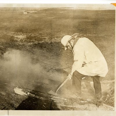 Fireman digging: "Brush fire"