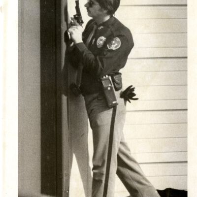 "Right" - Police or security officer holding gun, looking around corner