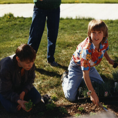 Two Boys Planting Flowers at the Broomfield Depot Museum