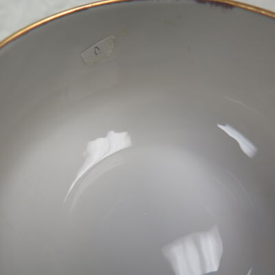 Close up of sticker on saucer.: Origsize: 2.25"(h) x 4" (w) x; Origformat: Artifact