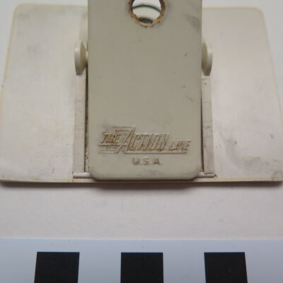 Close up on text on back of nametag.: Origsize: 3" (w) x 2.25" (l); Origformat: Artifact