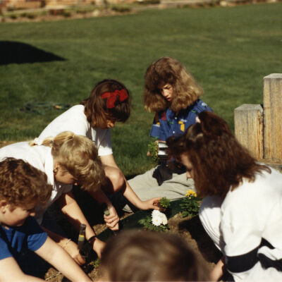 Kids Planting Near the Broomfield Historical Depot Sign