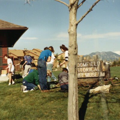 Kids Planting Near the Broomfield Historical Depot Sign and Museum