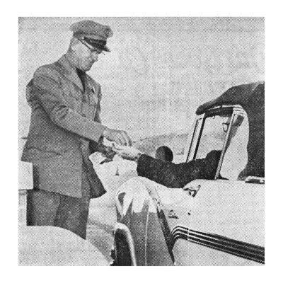 Tollbooth Worker Collecting a Toll From a Passenger