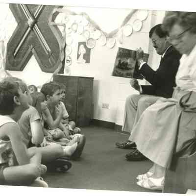 Mary Jane Bailey and Charles Ozaki Reading to Children