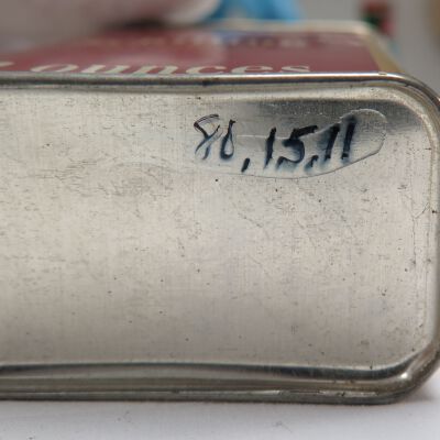Bottom of tin: Origsize: 3" (h) x 2.25" (w) x; Origformat: Artifact