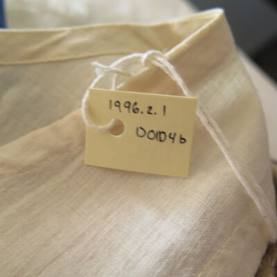 Tag of dress: Origsize: 24" (w) x 34" (l); Origformat: Artifact