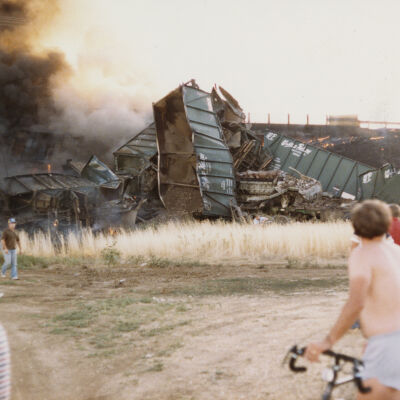 Bicyclist and Others Overlooking Train Wreckage Near US 36 in Broomfield