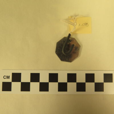 Back of tag.: Origsize: 1" (w) x 1" (l); Origformat: Artifact