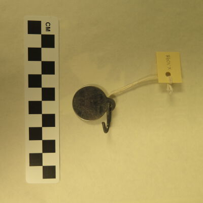 Back of tag.: Origsize: 1" (dia); Origformat: Artifact