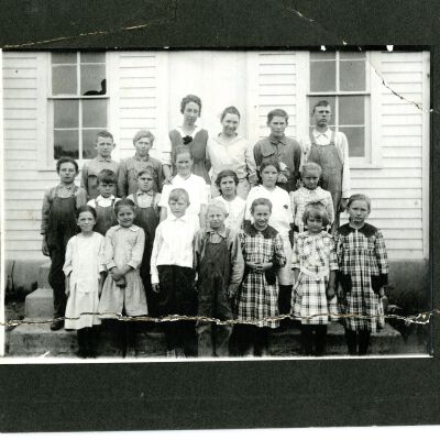 Teacher and students standing in front of Old Broomfield School