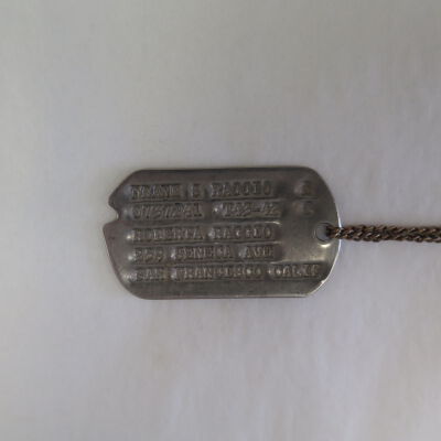 Close up of text on dog tag.: Origsize: 2" (w) x 1" (l); Origformat: Artifact