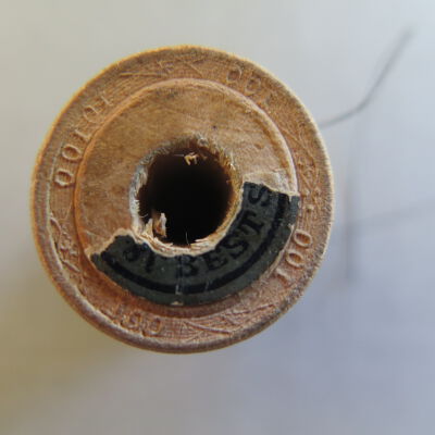 Close up of text on spool.: Origsize: 1" (h) x 0.75" (diam; Origformat: Artifact