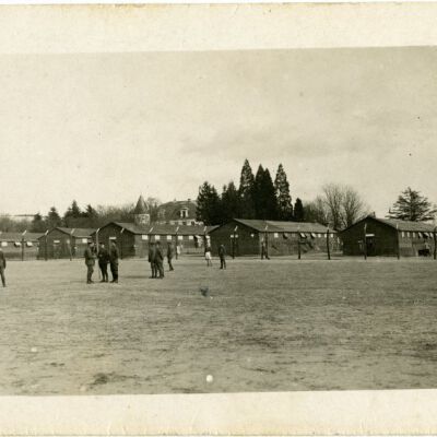 Soldiers in an open field with barracks in the background, circa 1918: Origsize: 3.5" x 5.5"; Origformat: Print-Photographic; Resolution: 950dpi