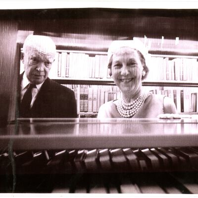 Mamie and Ike Eisehower looking through bookshelves at library dedication