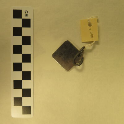 Back of tag.: Origsize: 1.5" (w) x 1.5" (l); Origformat: Artifact