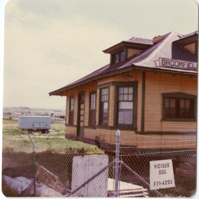 Front of Broomfield train depot fenced off after move, 1976: Origsize: 3.5" x 3.5"; Origformat: Print-Photographic; Resolution: 1500dpi