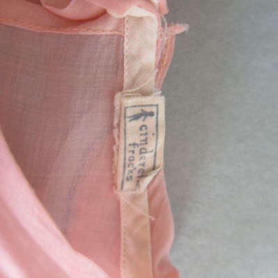 Tag on dress: Origsize: 10" (w) x 24" (l); Origformat: Artifact