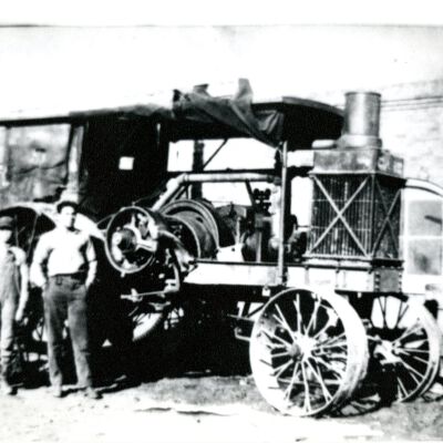 Men in front of Case Engine