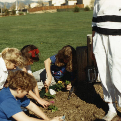 Kids Planting Near the Broomfield Historical Depot Sign