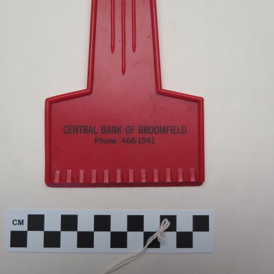 Close up of text on front of ice scraper.: Origsize: 3.75" (w) x 9.5" (l); Origformat: Artifact