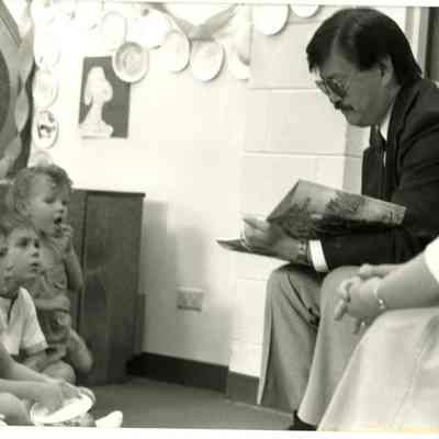 Charles Ozaki and Mary Jane Bailey Reading to Children