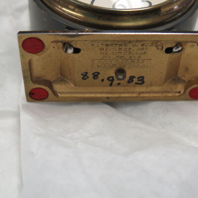 Bottom of alarm clock.: Origsize: 3" (h) x 3" (w) x 1.; Origformat: Artifact