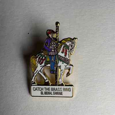 Pin: Shriner riding a white carasoul horse. "Catch the Brass Ring/ El Bekal Shrine" Belonged to PGM James O. Wood.
